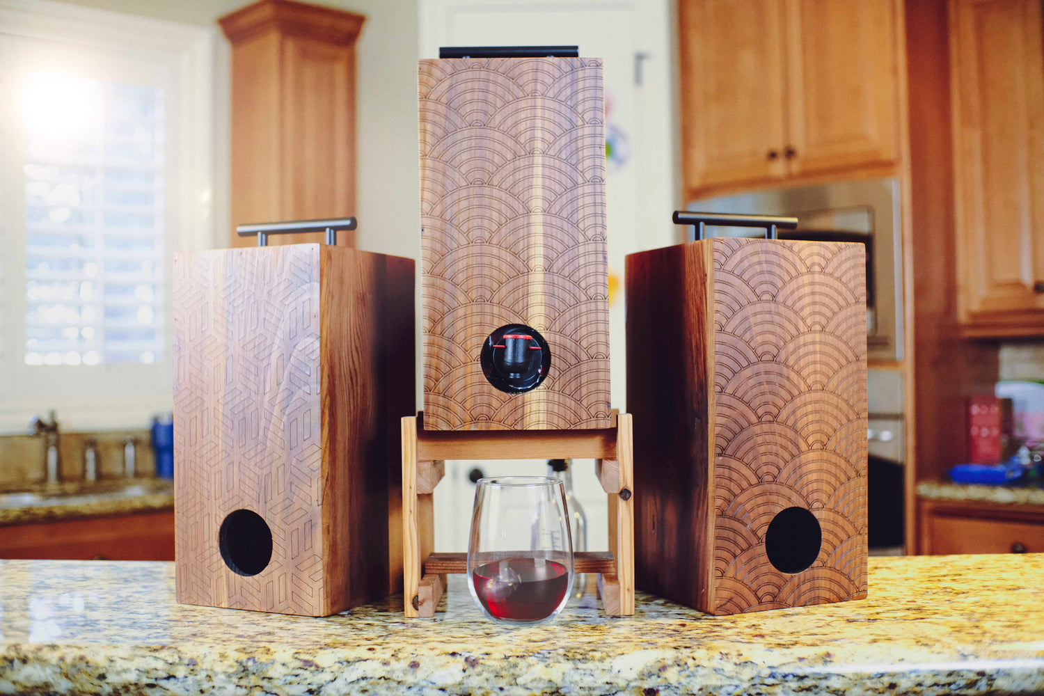 Weekend Walls wine box dispenser  on wood stand with wine glass